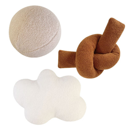 Coussin en peluche à forme géométrique avec boule et corde nouée